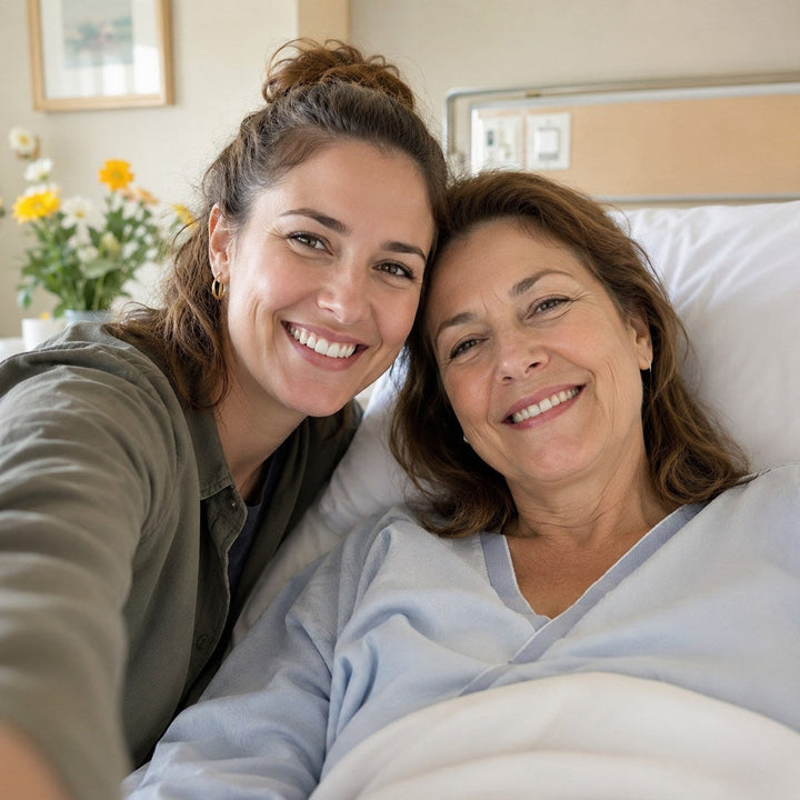 Patient and caregiver smiling in hospital room after hip replacement surgery, illustrating recovery support and dressing guidance after surgery.