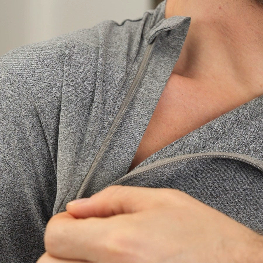 A close-up of one chest zipper on a gray chest-access shirt