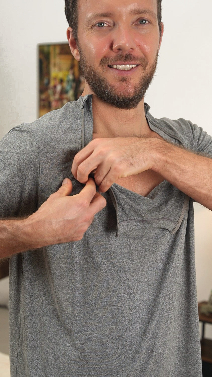 A person demonstrating the chest zipper on a gray shirt