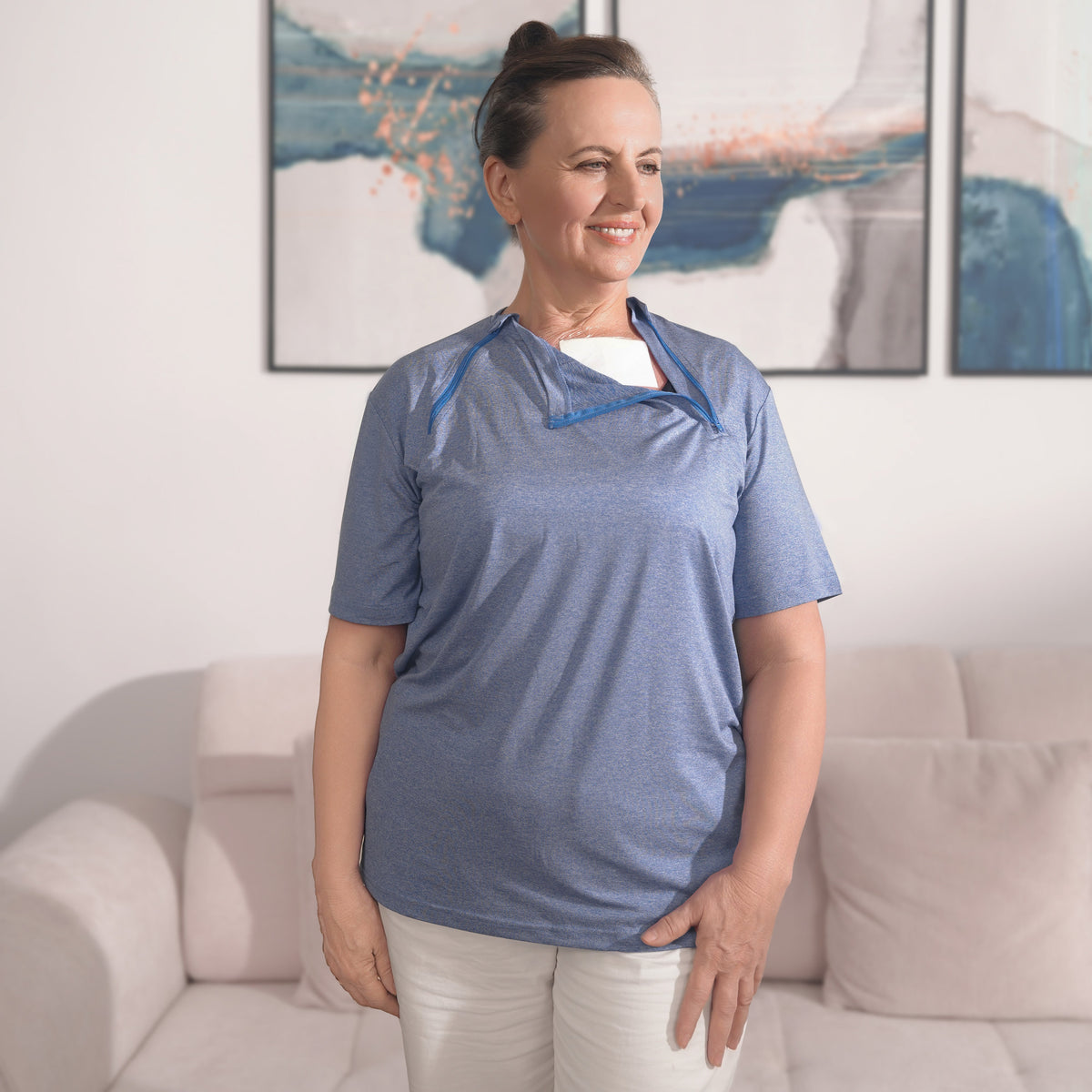 Woman wearing a Cloud Blue port-access shirt with the chest panel partly open