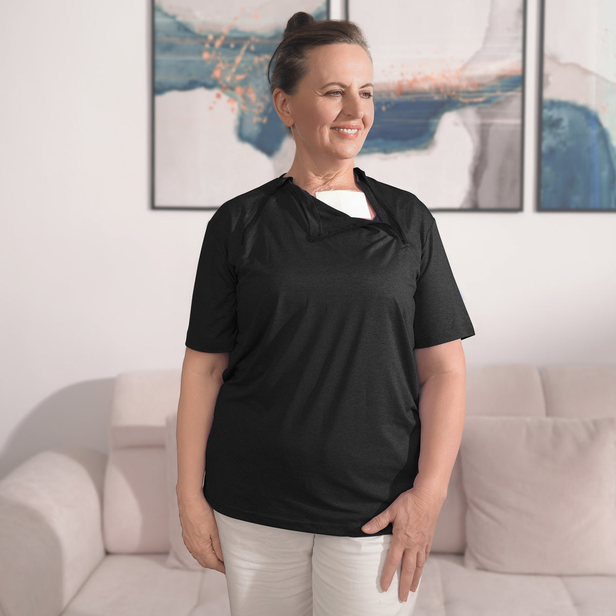 Woman wearing a Black port-access shirt with the chest panel partly open.