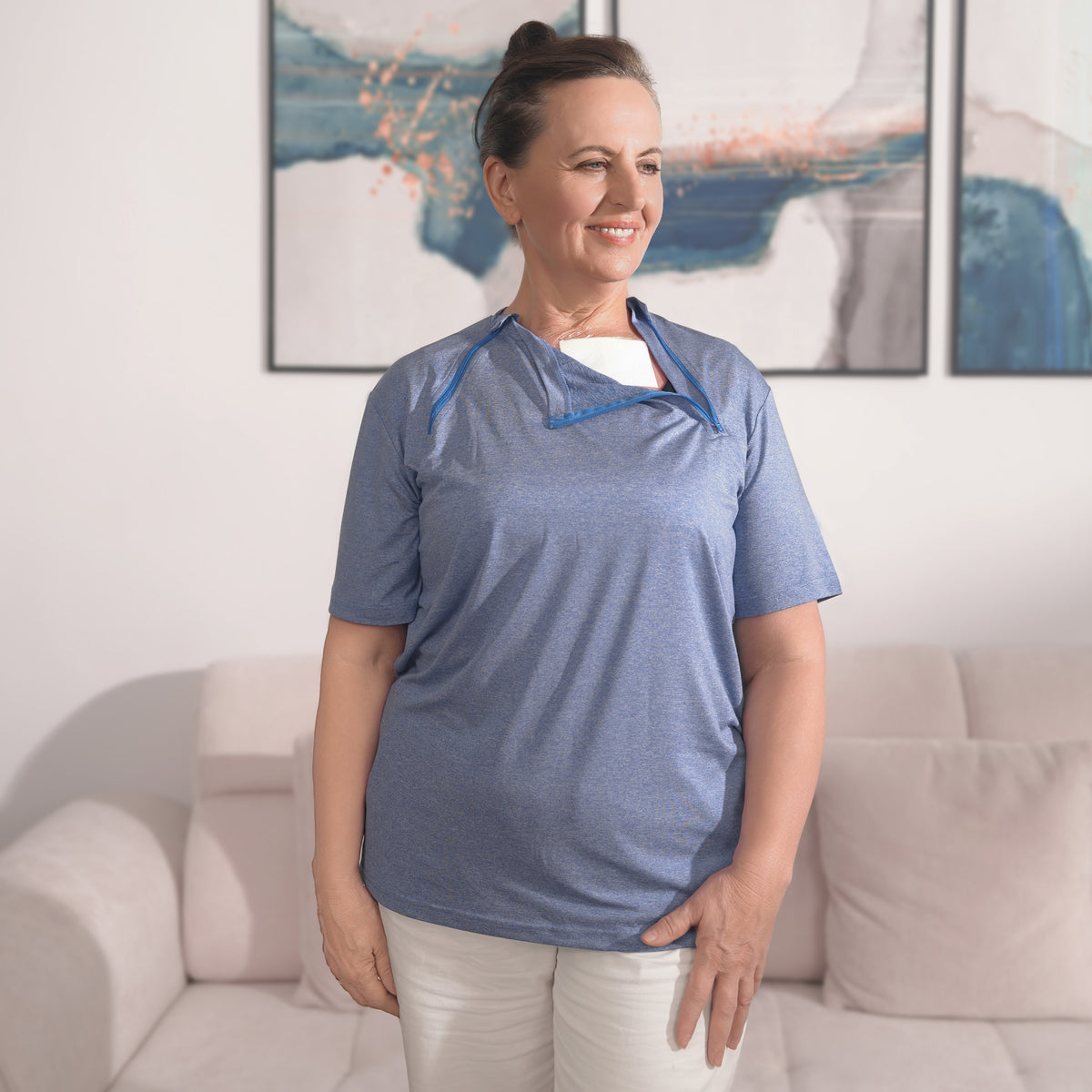 Woman wearing a Cloud Blue port-access shirt with the chest panel partly open.
