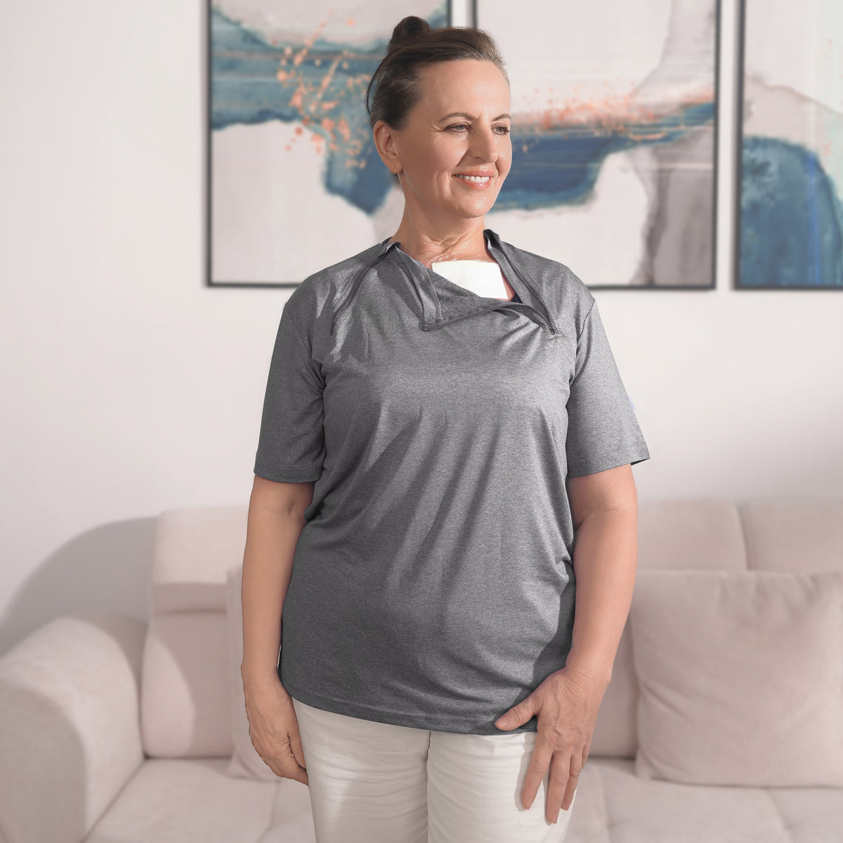 Woman wearing a Gray port-access shirt with the chest panel partly open.
