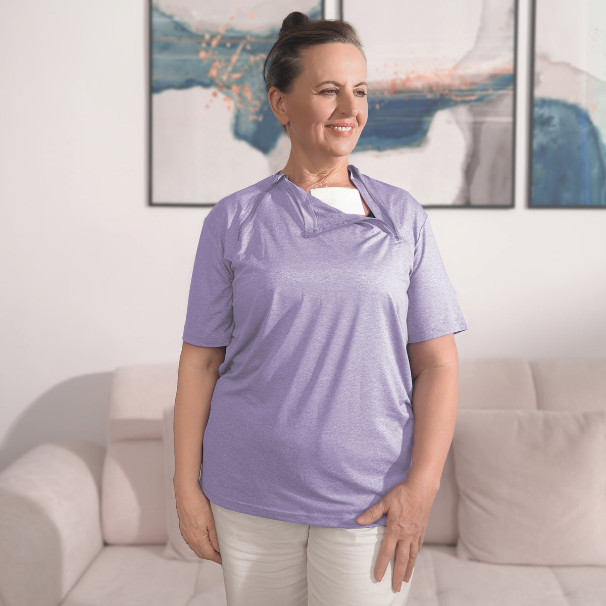 Woman wearing a Lavender Mist port-access shirt with the chest panel partly open.