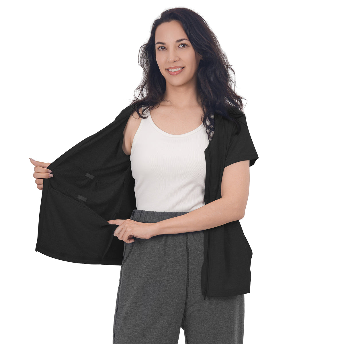 Woman holding a Black front-zip shirt open to show the inner pockets.