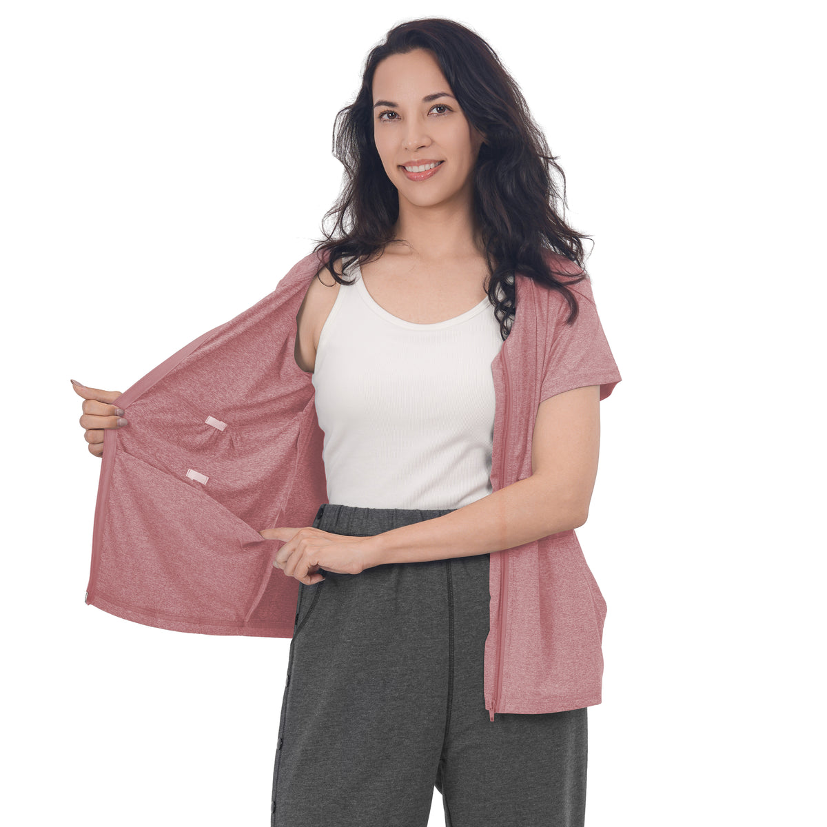 Woman holding a Dusty Rose front-zip shirt open to show the inner pockets.