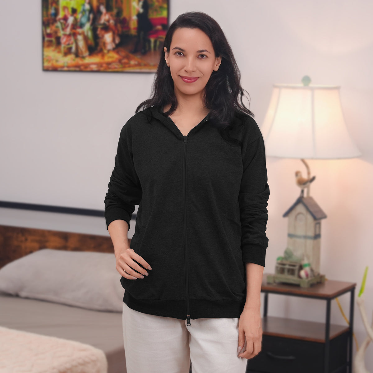 Woman wearing a Black zip hoodie.