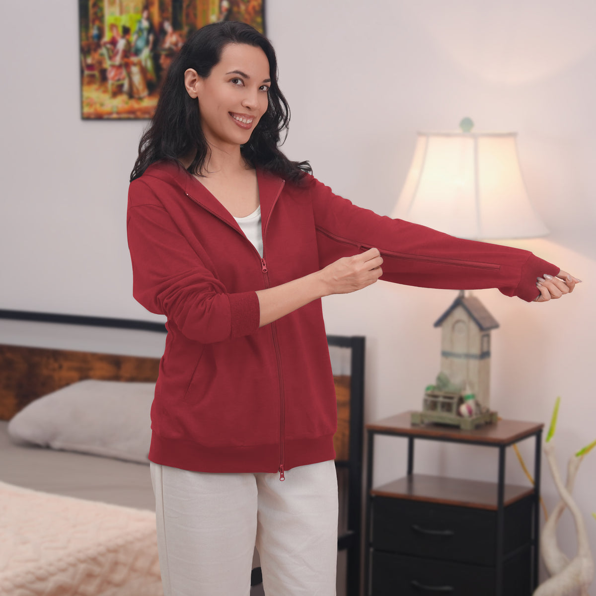 Woman showing the sleeve zipper on a Red zip hoodie.
