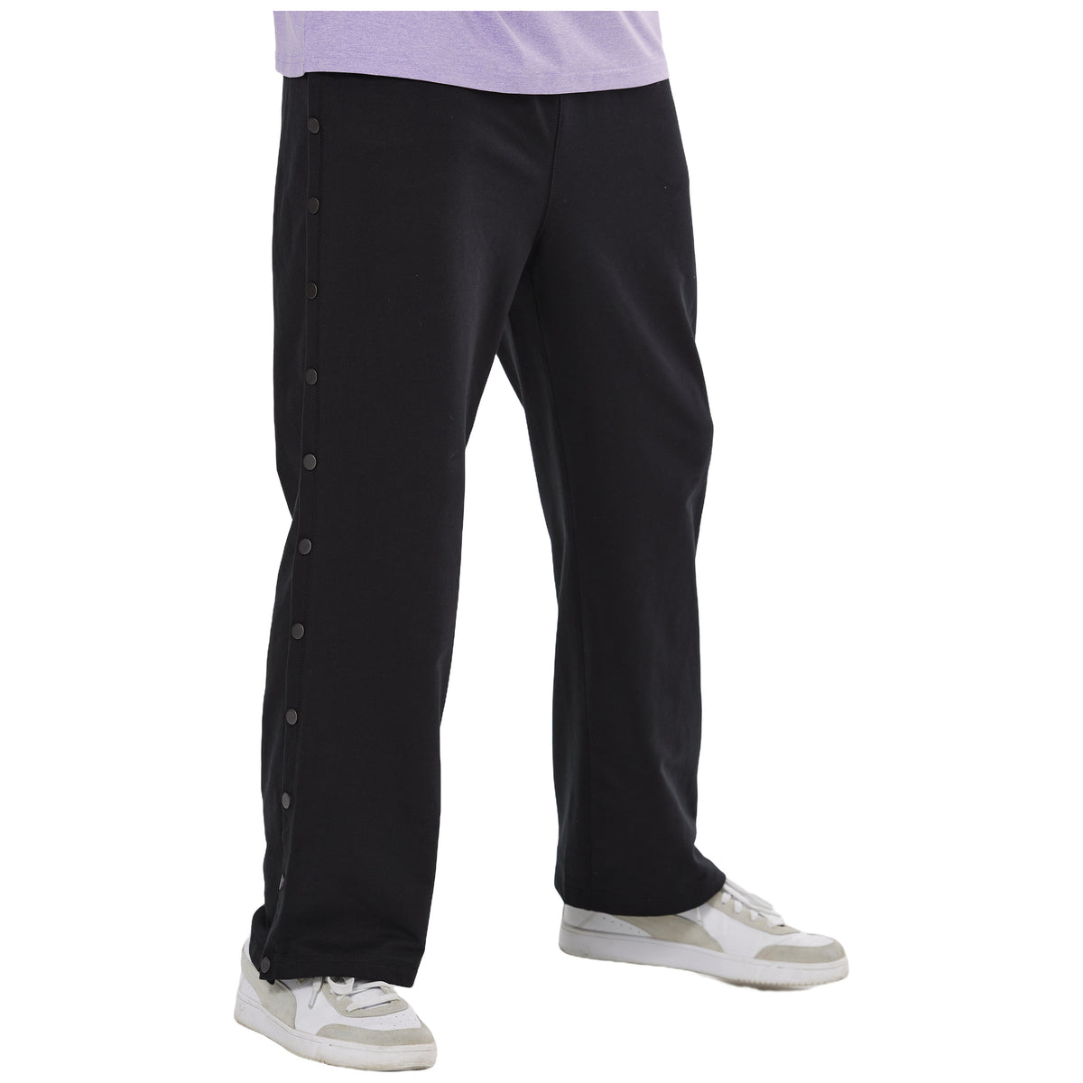 Man wearing Black side-snap recovery pants with the side fastenings closed.