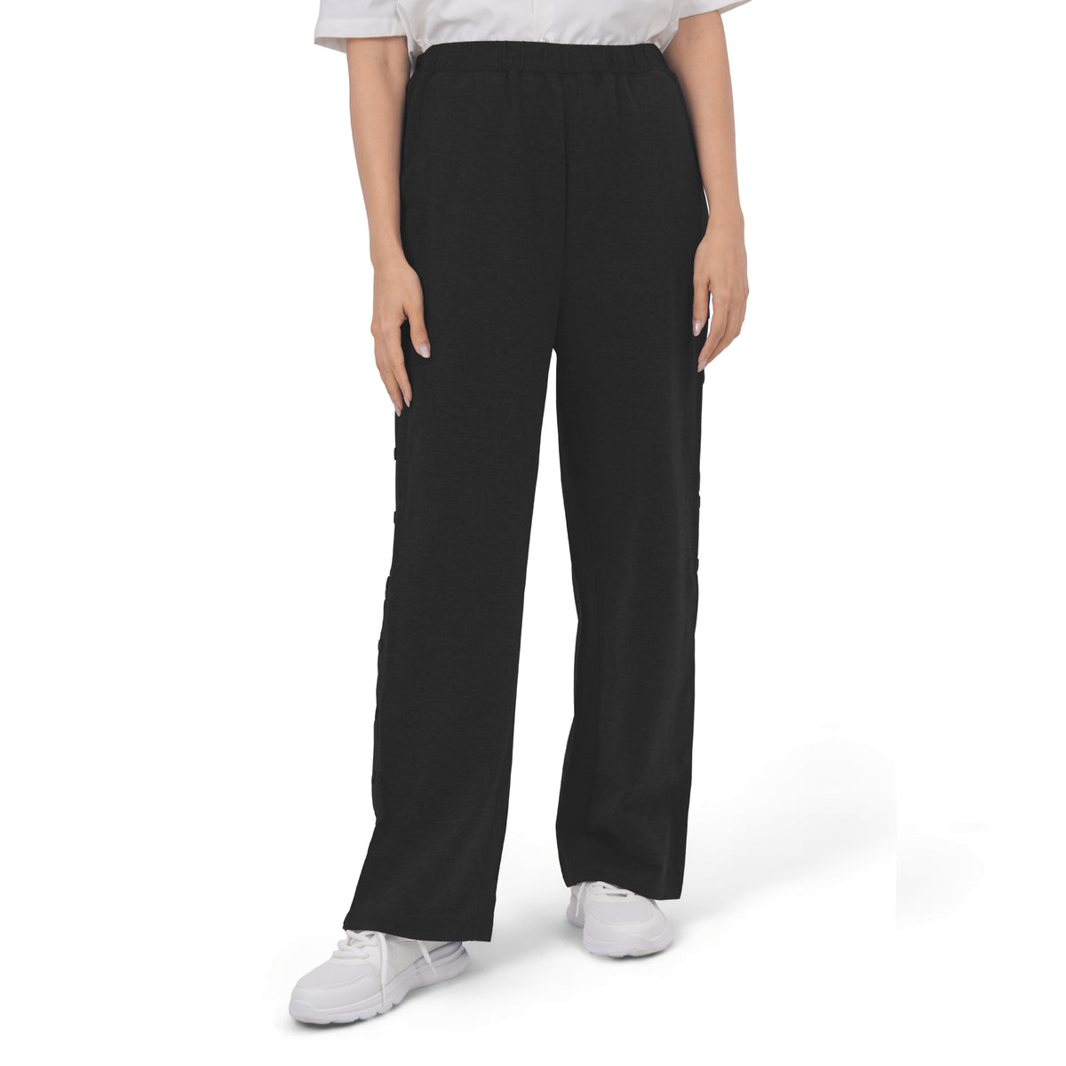 Woman wearing Black recovery pants, front view.