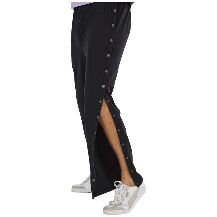 Man wearing Black side-snap recovery pants with one side panel open. #black_group