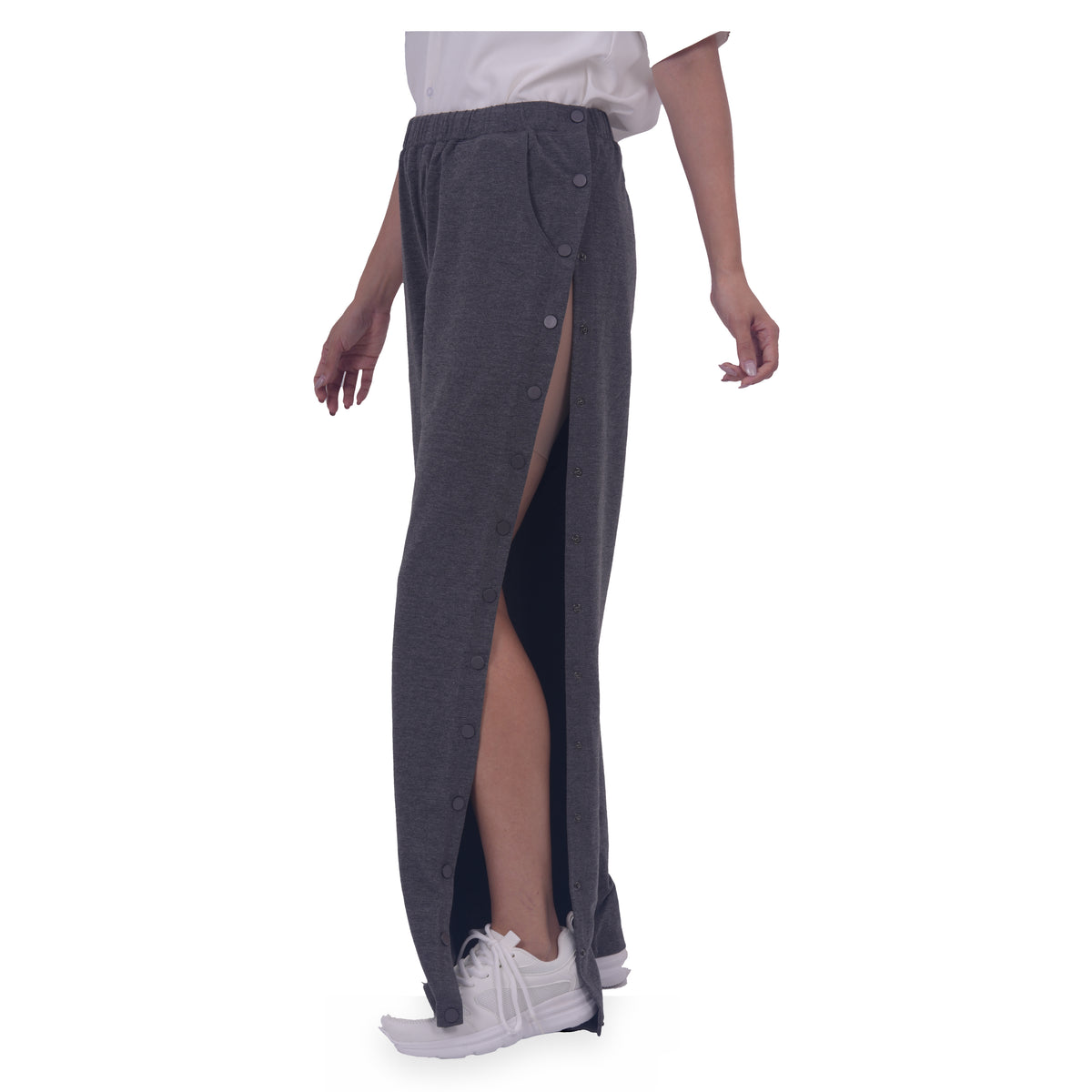 woman wearing gray side-snap recovery pants with one side panel open.