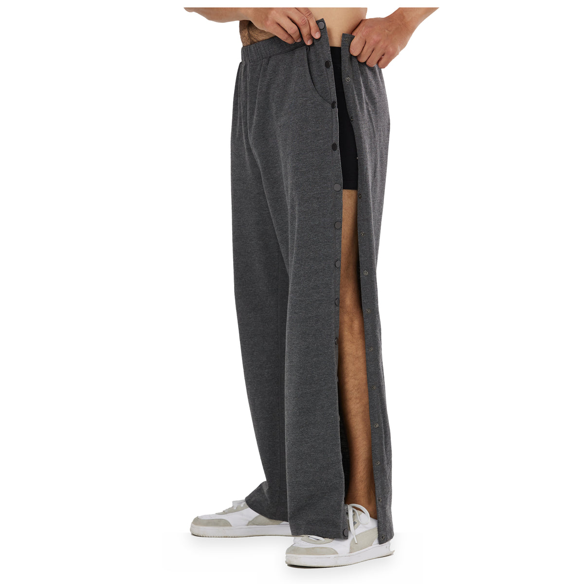 Man wearing gray side-snap recovery pants with one side panel open.